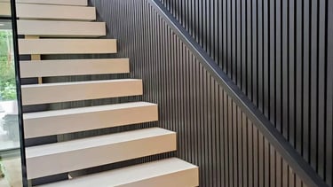 Modern floating staircase design with vertical slat wall feature in a luxury Vancouver home