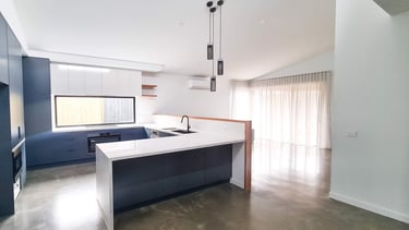 a kitchen with a large island and a large window