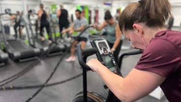 woman on stationary bike at 6X Training