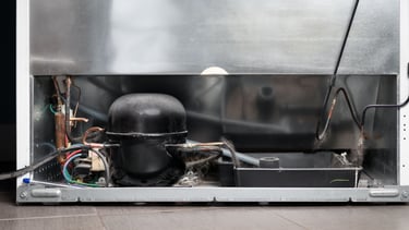a refrigerator with a large metal container inside