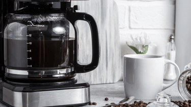 a coffee maker with coffee beans and coffee beans