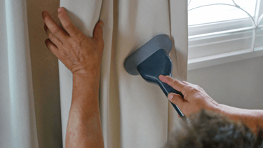a person cleaning a window with a brush