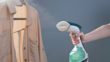 a person is holding a bottle of liquid in front of a dress