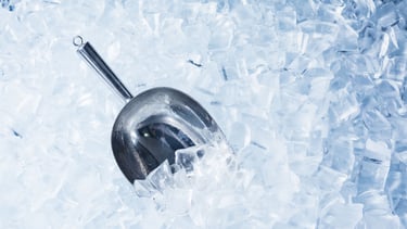 a spoon with a spoon in it sitting on ice