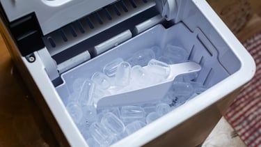 a plastic container filled with ice and a spoon