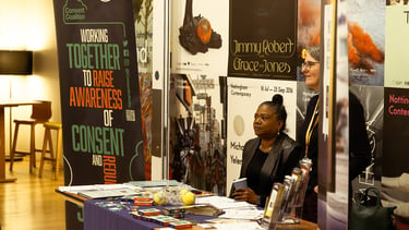 a woman standing in front of a table with a table with a table cloth