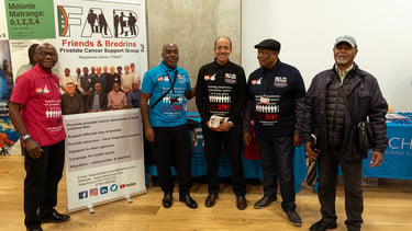 a group of people standing around a banner board
