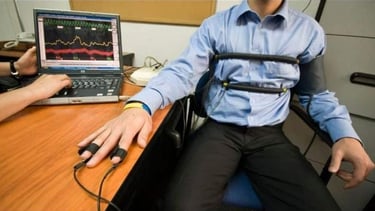 a man in a wheelchair with a computer monitor and a laptop