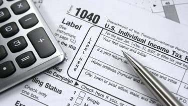 a calculator and pen on a tax form. Taxes 1040. 1040 Form. 