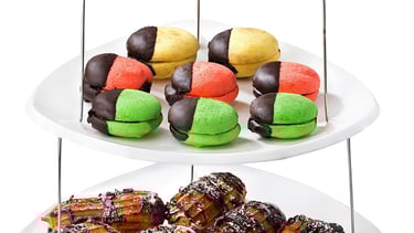 a three tiered tray of pastries with pastries