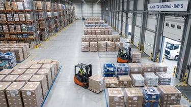 An organized warehouse view with neatly palletized goods ready for loading.