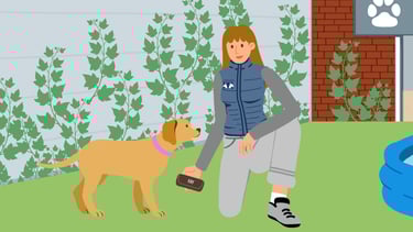 a woman waring a blue vest is playing with a brown dog in a garden
