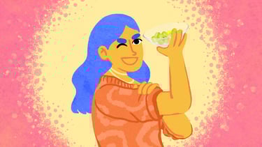 a girl imitates the "we can do it" poster with her arm up holding a bowl of grapes