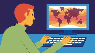 a man sitting at a desk with a computer monitor and a keyboard, the world's map on the screen