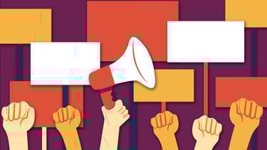 a bunch of hands demonstrating, holding up banners and a megaphone