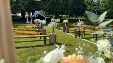 a cross - country wedding ceremony with flowers and a cross