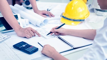 a team of professionals in hard hats and safety vests collabrating in a project