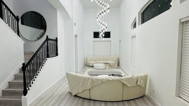 a beautifully remodeled living room with a staircase