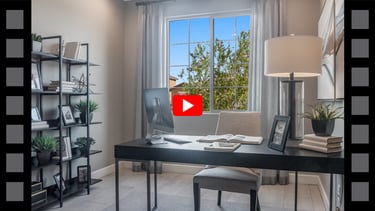 a desk with a laptop and a lamp