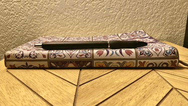 a journal and a pen on a table