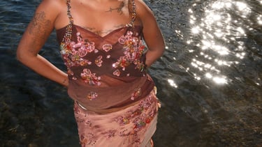 a woman in a dress with a large afro - american afro - american hair