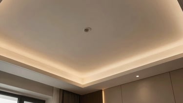 A minimalist false ceiling design with integrated warm LED lighting in a South Asian / Indian master bedroom, emphasizing contemporary elegance.