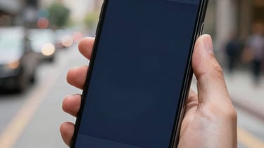 A close-up of a mobile device held by a user in a well-lit North American / US urban environment, displaying a sleek dark navy blue app interface.
