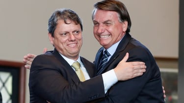 two men in suits and ties are hugging each other