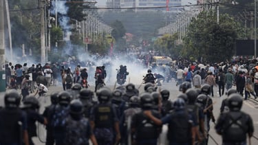 a group of people standing in front of a group of police officers