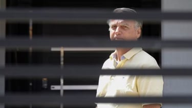 a man in a yellow shirt and tie dyes a tie