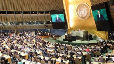 a large group of people sitting in a large room