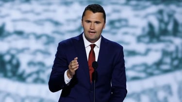 a man in a suit and tie is giving a speech