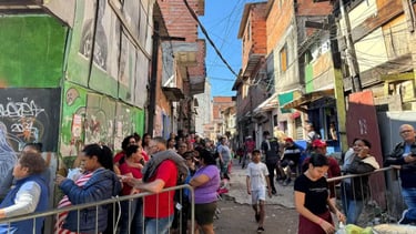 a group of people standing in line at a street corner