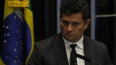 a man in a suit and tie is standing at a podium