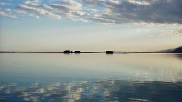 a boat on the water with clouds in the background