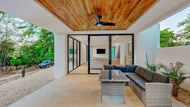 a patio with a couch and a ceiling fan