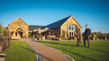 man and woman standing in front of wedding venue