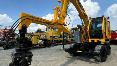 a yellow excavator with a crane on the back of it