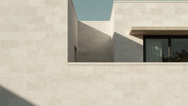 Clean minimalist architectural photography of a modern residential structure in Western Mexico constructed with white AAC blocks, soft natural daylight casting long shadows, professional and serene atmosphere, off-white and charcoal green color palette.