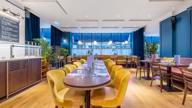 a restaurant with a long table and chairs