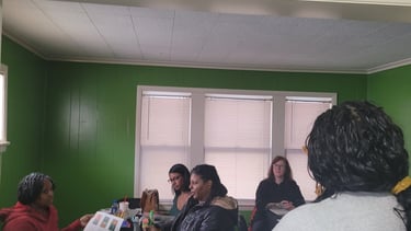 Diverse group of women participating in a collaborative workshop or educational seminar in a green room.