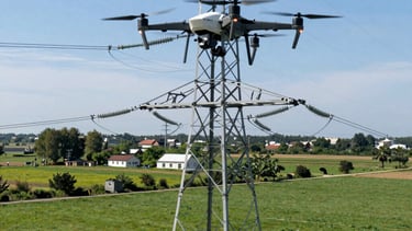 A drone flying over a forested area during a clear day capture survey.