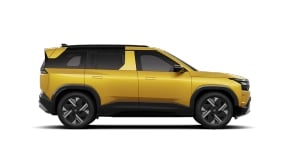 Side profile of yellow Tata SUV Accomplished variant with premium styling and dual-tone alloy wheels