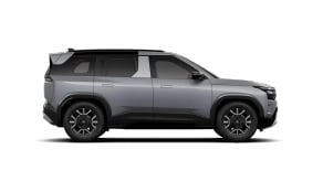 Side view of grey Tata SUV Adventure variant with rugged styling and dark alloy wheels.