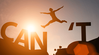 a person jumping over a sign that says can't