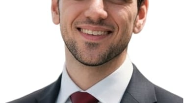 a man in a suit and tie smiling