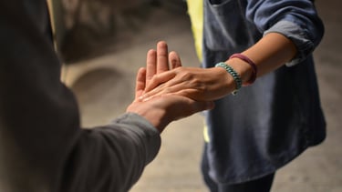 a person holding a hand out to a person