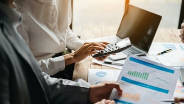a group of people sitting at a table with papers and papers