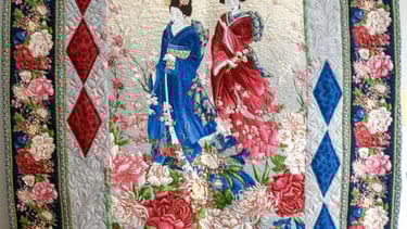 Traditional quilt featuring a central panel with decorative pieced borders.