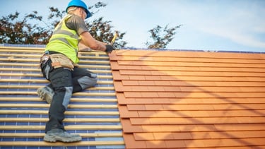 man installing a new orange roof